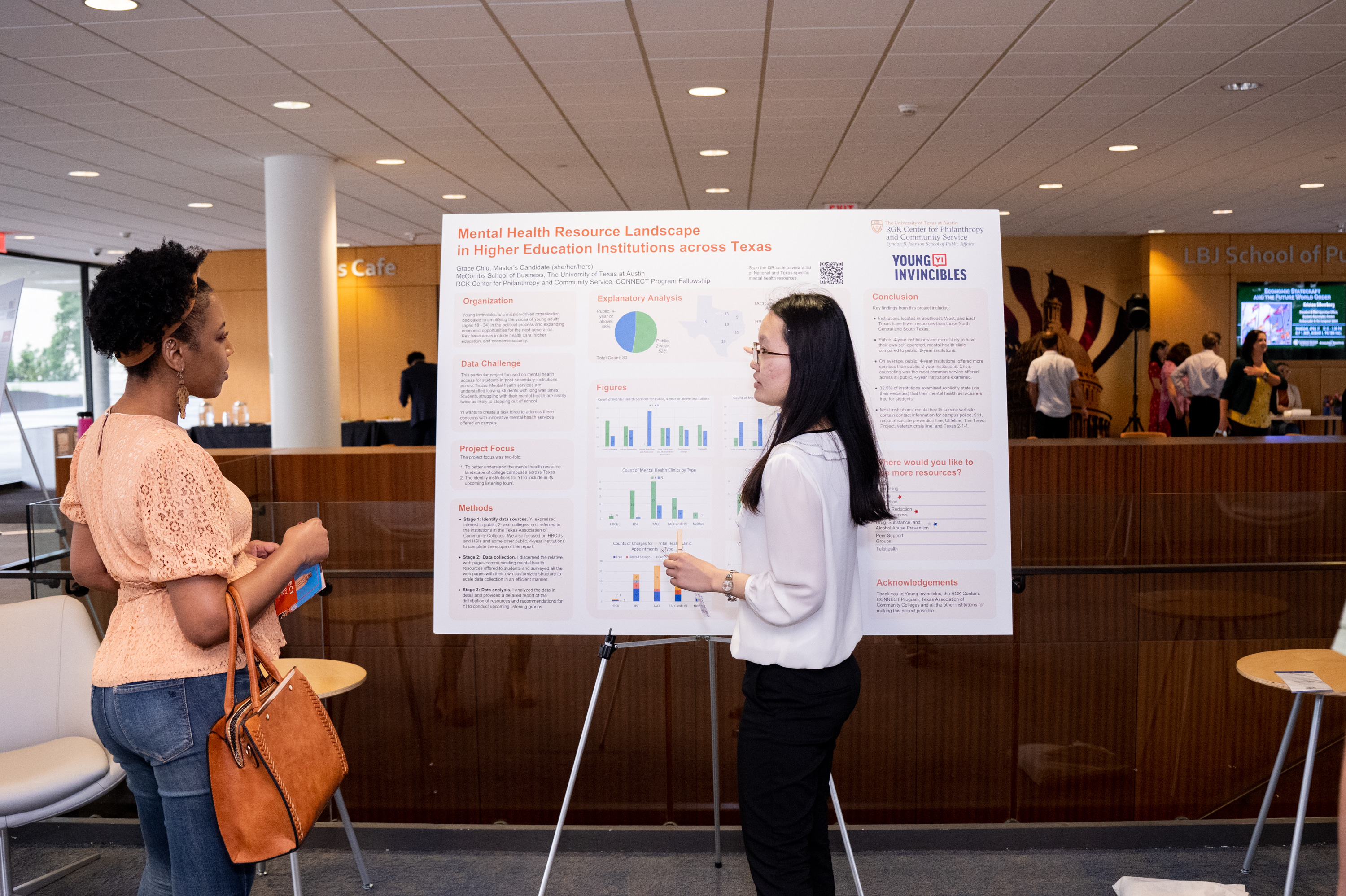 Grace Chiu shares her poster with an attendee at the CONNECT Community Showcase.