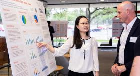 Grace Chiu sharing her poster with Dean DeShazo at the CONNECT Community Showcase